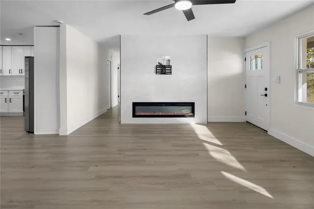 a view of an empty room with a ceiling fan