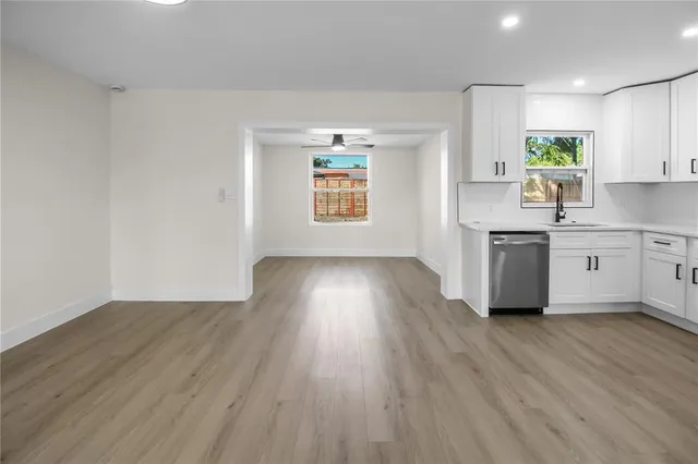 a kitchen with wooden floors and white appliances