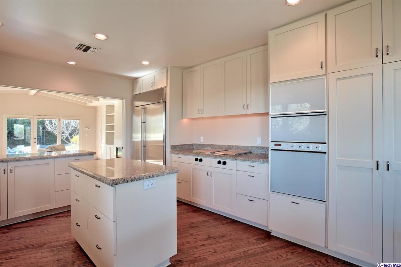 1114 Heatherside Road Pasadena, CA 91105 - Photo 11 of 35 a kitchen with white cabinets and white appliances
