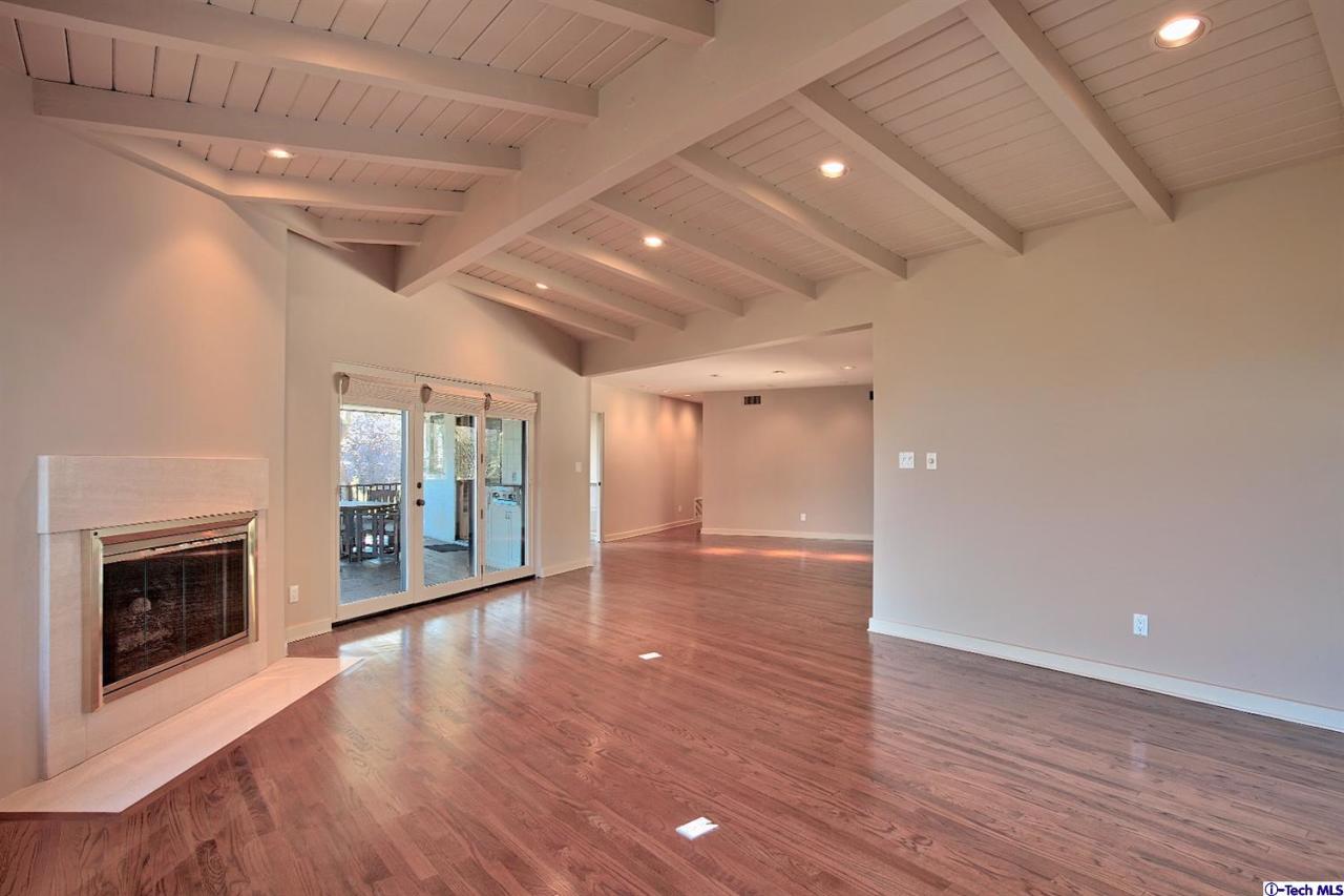 1114 Heatherside Road Pasadena, CA 91105 - Photo 14 of 35 a view of an empty room with wooden floor fireplace and a window