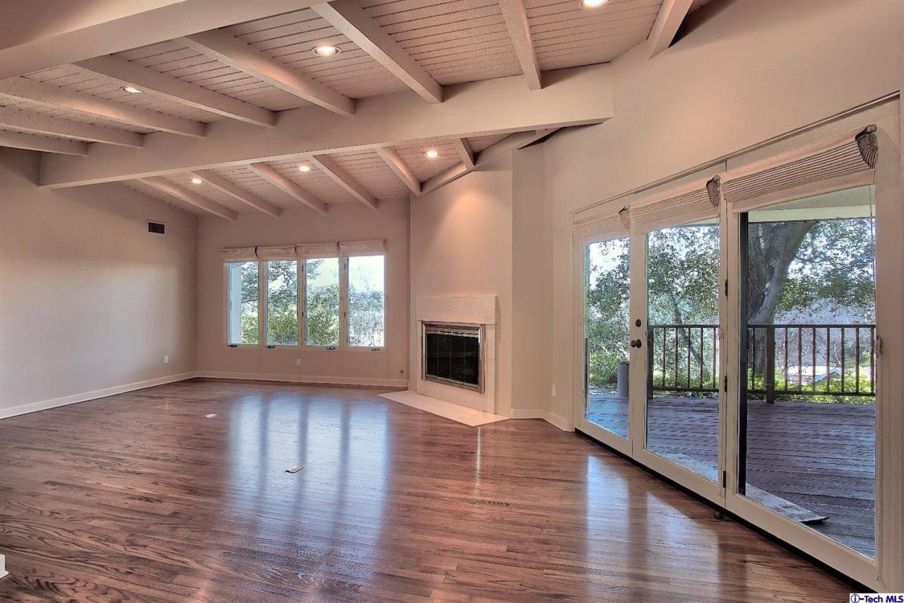 1114 Heatherside Road Pasadena, CA 91105 - Photo 15 of 35 a view of empty room with wooden floor and fireplace