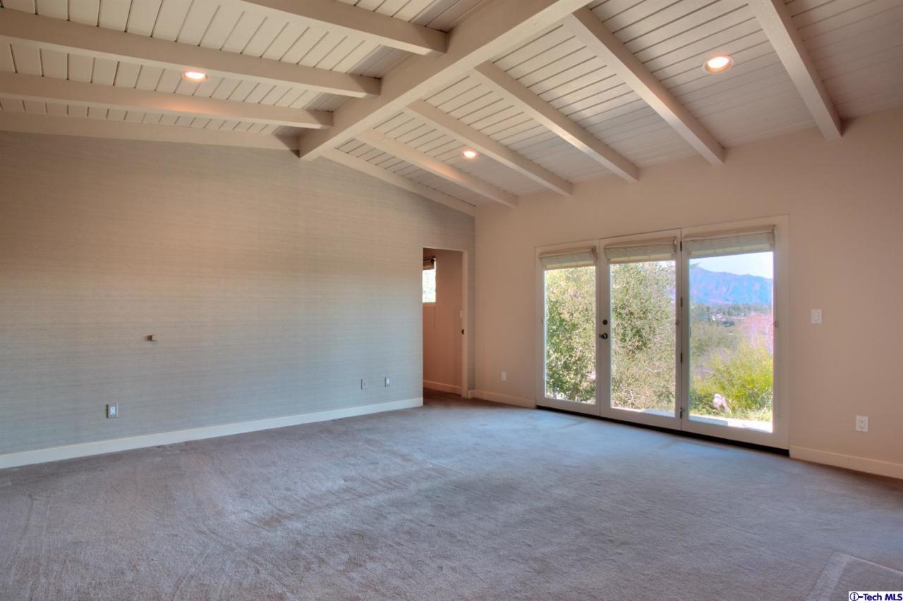 1114 Heatherside Road Pasadena, CA 91105 - Photo 17 of 35 a view of an empty room with windows and chandelier