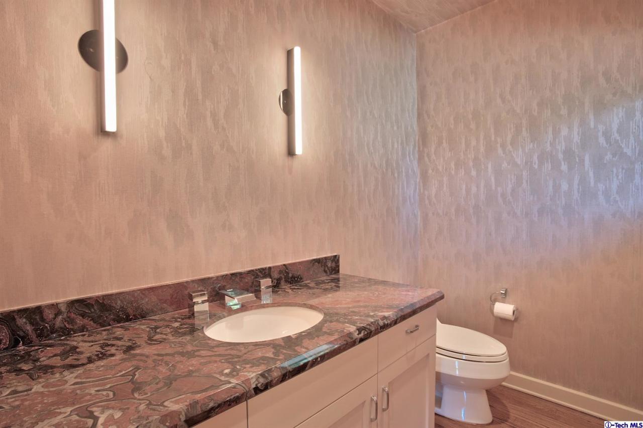 1114 Heatherside Road Pasadena, CA 91105 - Photo 23 of 35 a bathroom with a granite countertop sink toilet and mirror