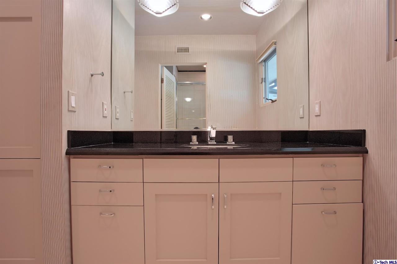 1114 Heatherside Road Pasadena, CA 91105 - Photo 25 of 35 a bathroom with a sink and cabinets