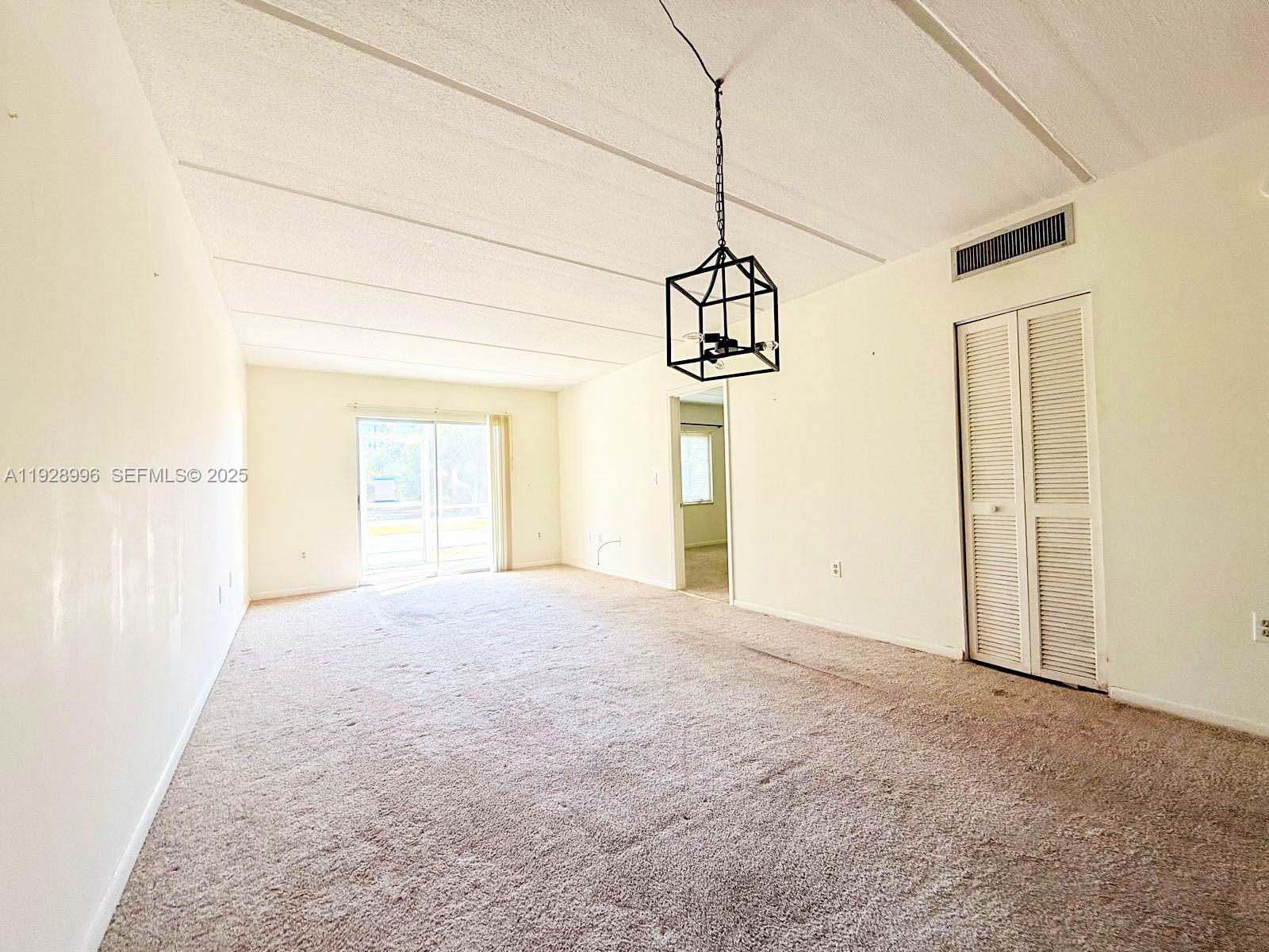 649 South Tamiami Trail, Unit 112 Venice, FL 34285 - Photo 12 of 25 a view of big room with windows and chandelier