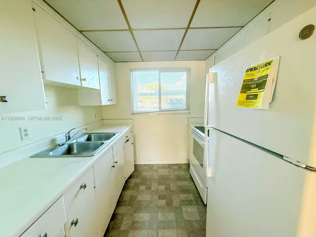 a kitchen with a sink and wooden cabinets