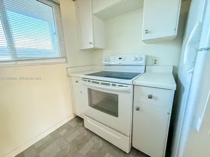 a kitchen with a stove and a refrigerator