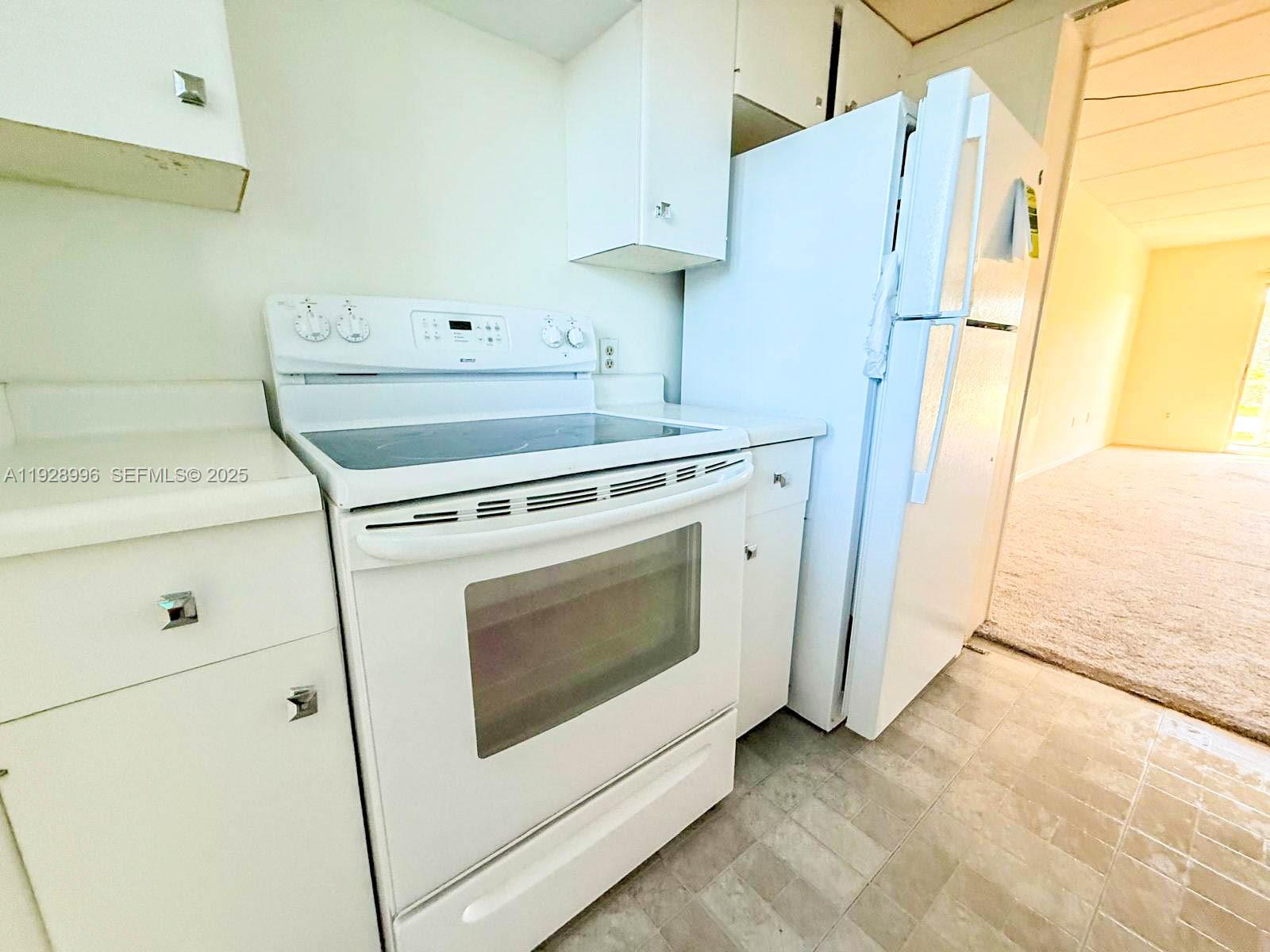 649 South Tamiami Trail, Unit 112 Venice, FL 34285 - Photo 15 of 25 a kitchen with a stove and a refrigerator