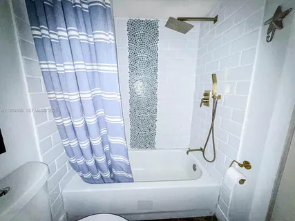 a bathroom with a shower toilet and sink