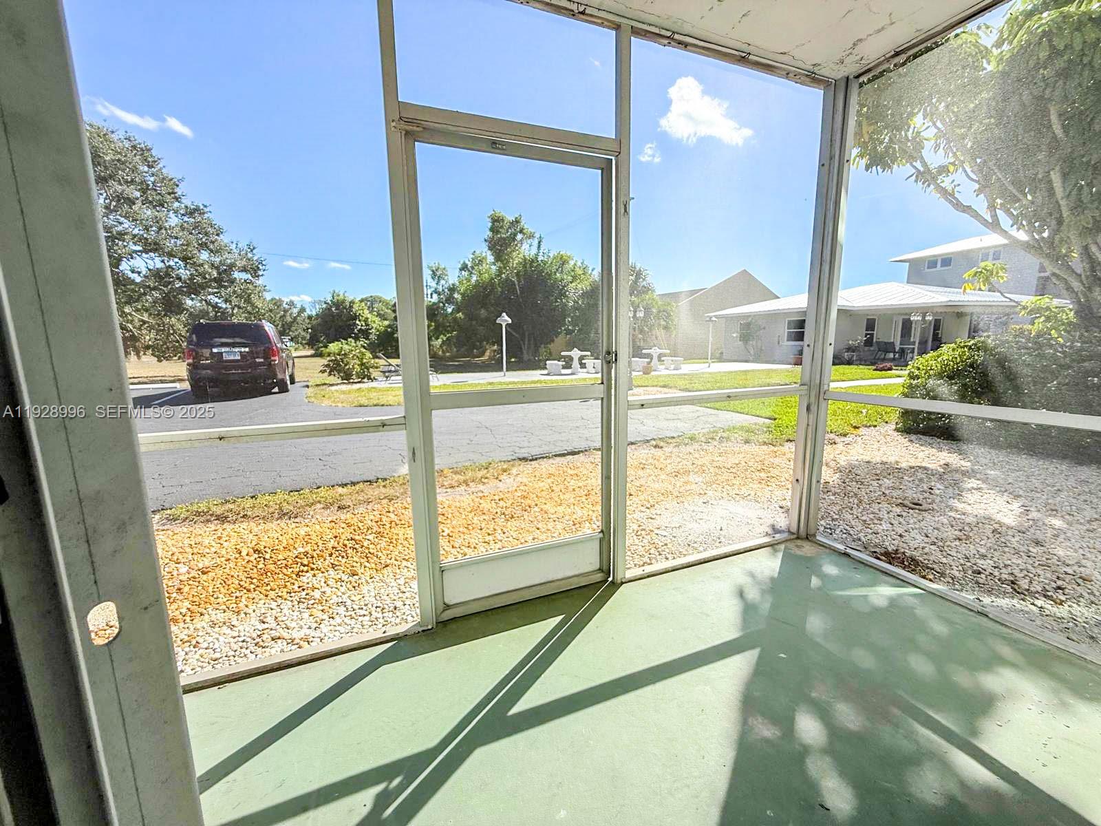 649 South Tamiami Trail, Unit 112 Venice, FL 34285 - Photo 22 of 25 a view of a glass door with a yard