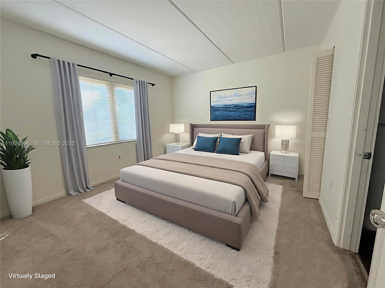 649 South Tamiami Trail, Unit 112 Venice, FL 34285 - Photo 6 of 25 a bedroom with a large bed and a potted plant