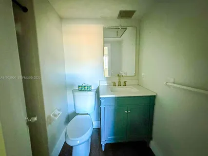 an empty room with closet and a bathroom