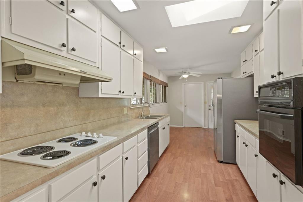 705 Edgewater Trail Sandy Springs, GA 30328 - Photo 4 of 36 a large kitchen with stainless steel appliances granite countertop a stove and a sink
