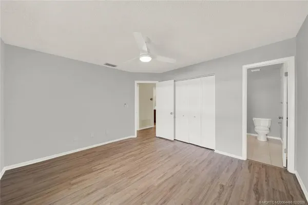 a view of an empty room with wooden floor