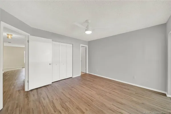 a view of an empty room with wooden floor