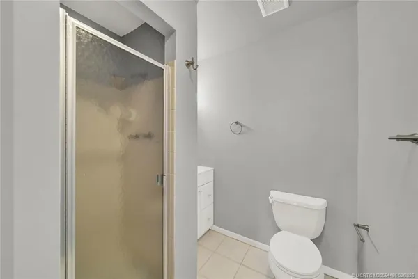 a white toilet sitting next to a bathroom sink