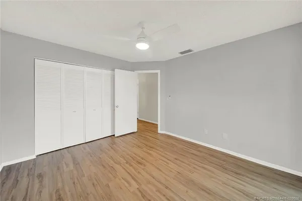 a view of an empty room with wooden floor