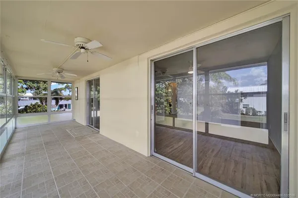 a view of a hallway with a dining table and chairs