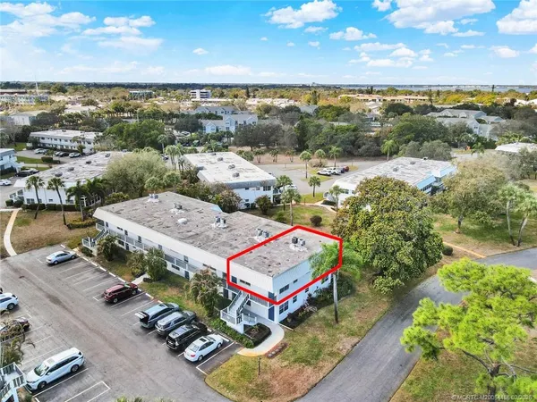 an aerial view of a houses with yard
