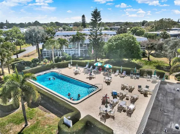 a view of a balcony with two chairs and a table