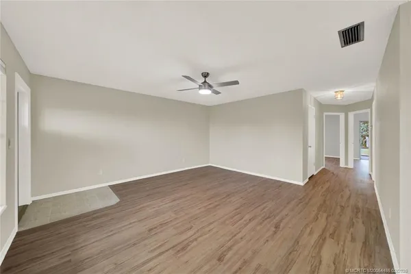 wooden floor in an empty room with a window