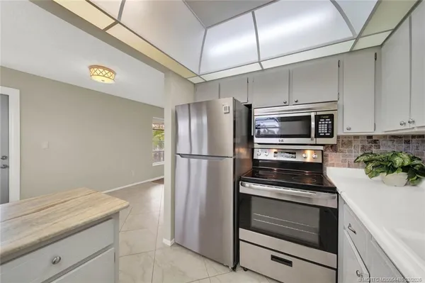 a kitchen with granite countertop a refrigerator and a stove