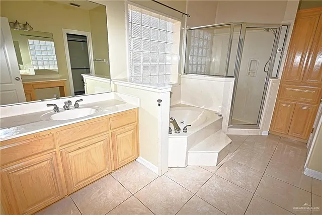 a en suite bathroom with a sink a mirror and a bathtub