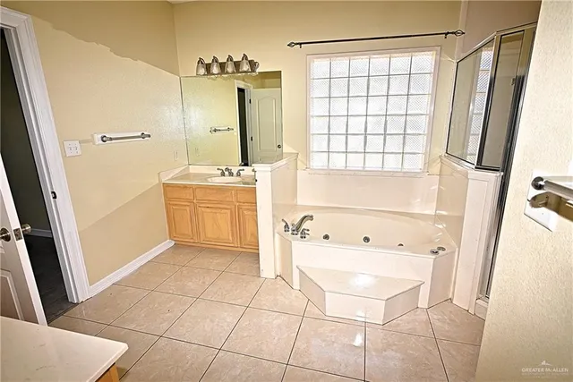 a bathroom with a bathtub a sink and a shower