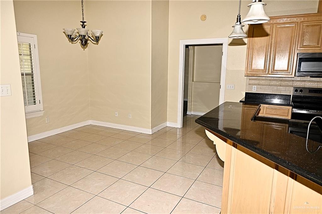 3509 Knight Avenue Edinburg, TX 78539 - Photo 2 of 18 a kitchen with kitchen island a counter top space appliances and cabinets
