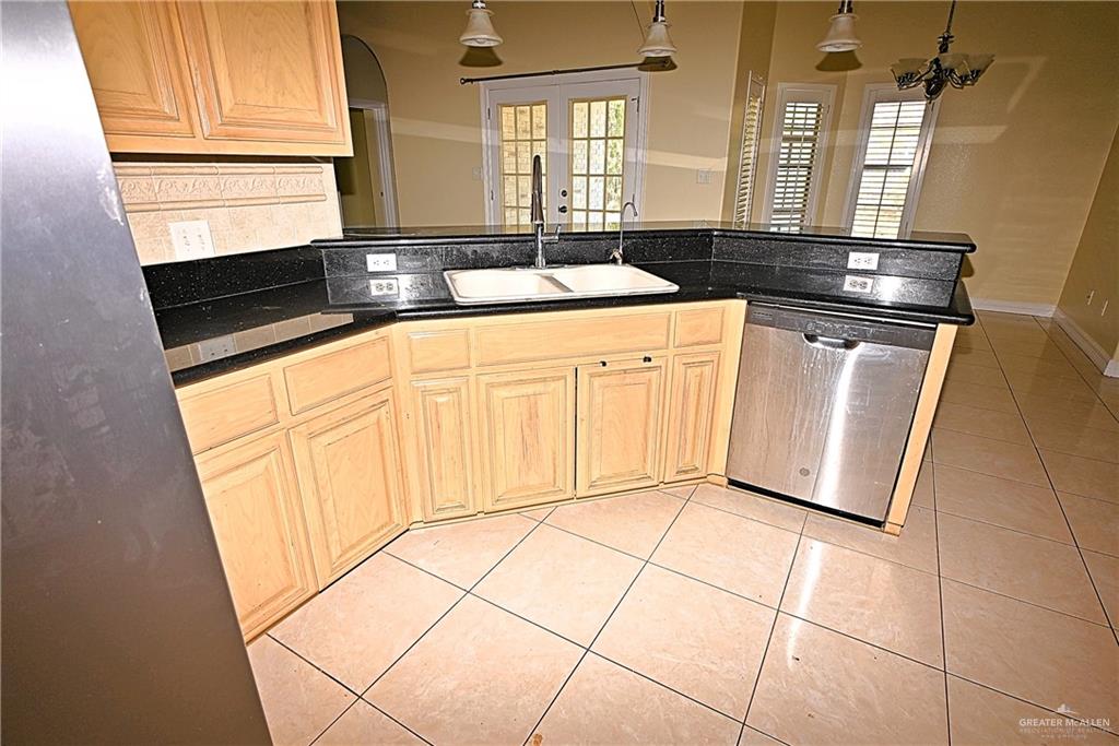 3509 Knight Avenue Edinburg, TX 78539 - Photo 10 of 18 a kitchen with stainless steel appliances granite countertop a sink and a cabinets