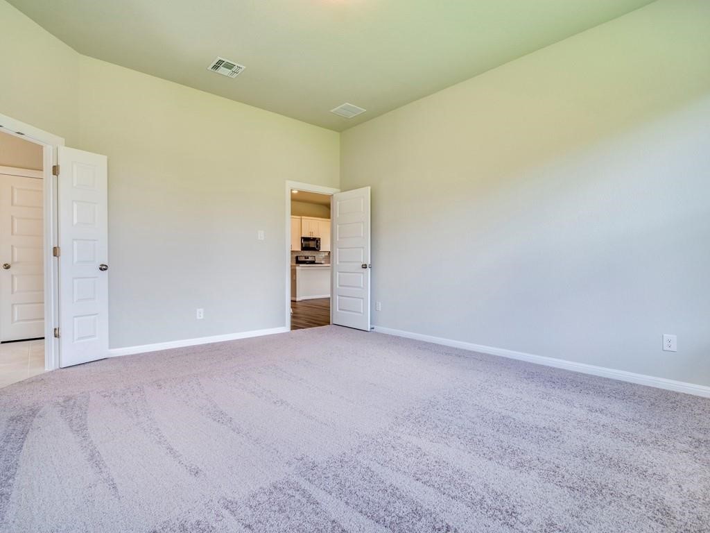 270 Rimrock Court Bastrop, TX 78602 - Photo 18 of 34 The primary suite is a true retreat, complete with a large walk-in closet, dual vanity, and walk-in shower.