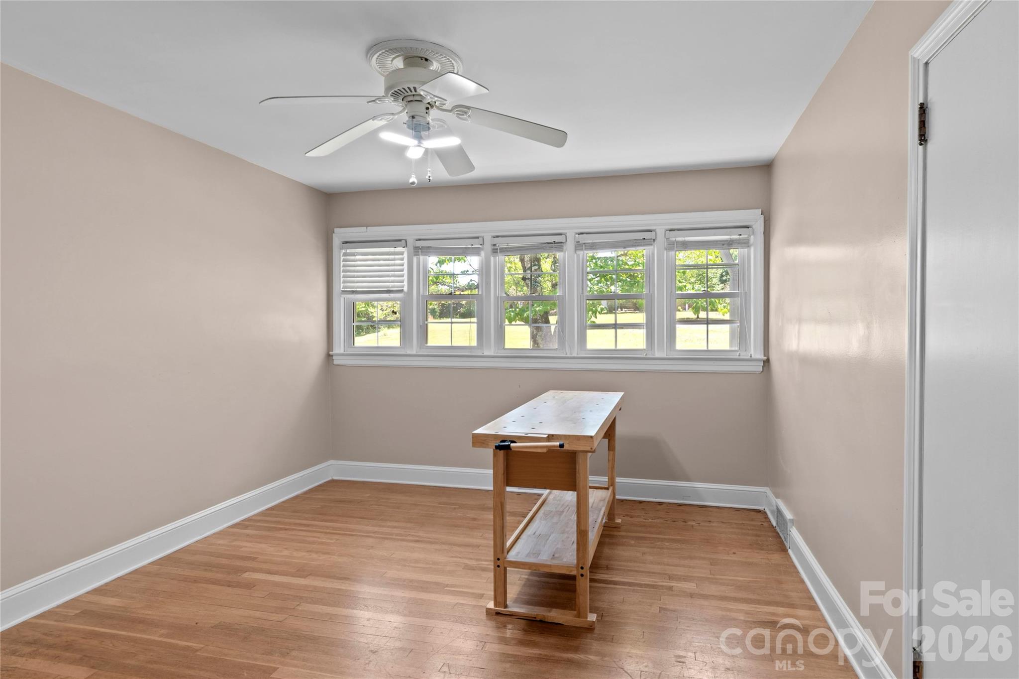 951 Dodson Mill Road Pilot Mountain, NC 27041 - Photo 26 of 48 a view of a room with wooden floor a ceiling fan and windows