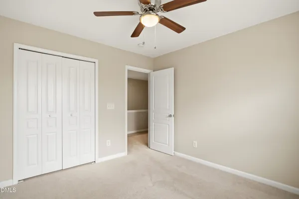 a view of a room with a ceiling fan