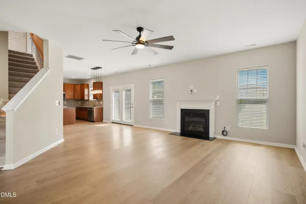 a view of an empty room with a fireplace and a window