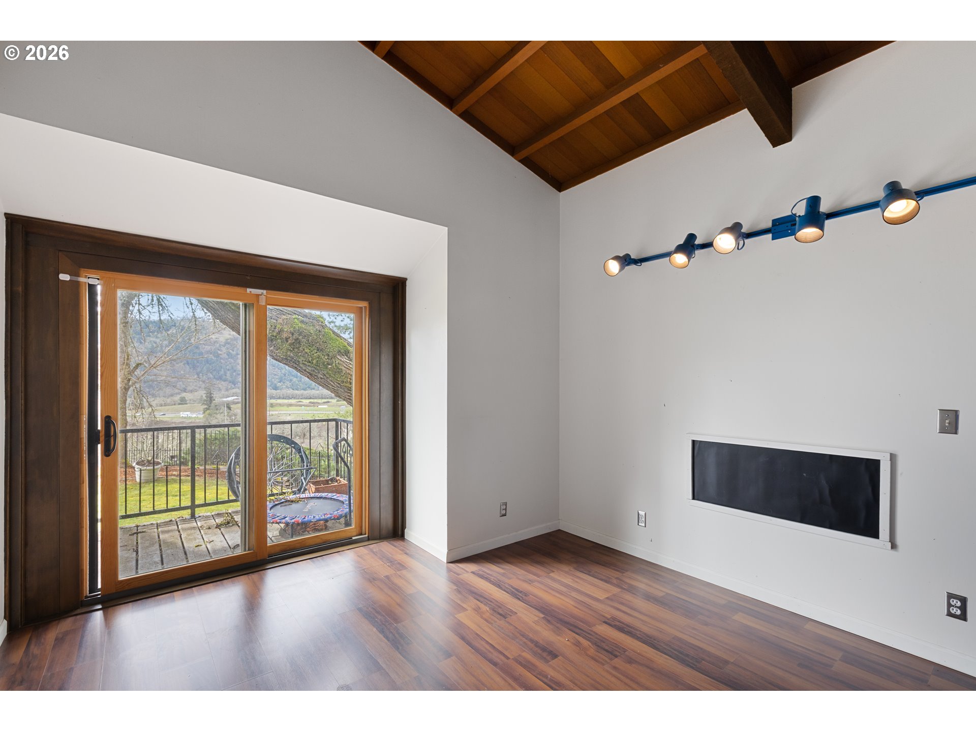 141 Umpqua College Road Roseburg, OR 97470 - Photo 19 of 45 a view of an empty room with a window and wooden floor