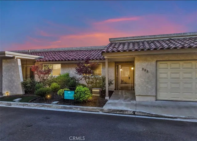 a view of a house with a potted plant and a window