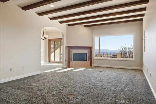 a view of empty room with a fireplace
