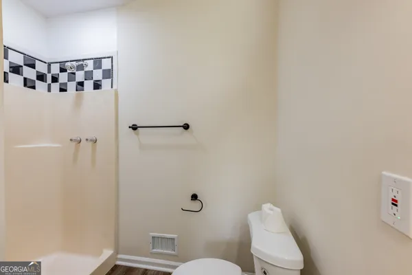 a white toilet sitting next to a bathroom sink