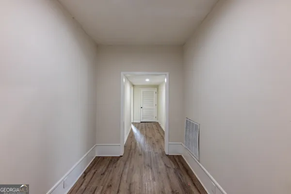 a view of hallway with wooden floor