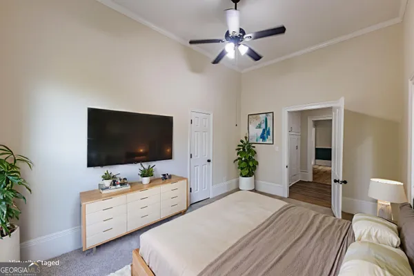 a bedroom with furniture and a flat screen tv