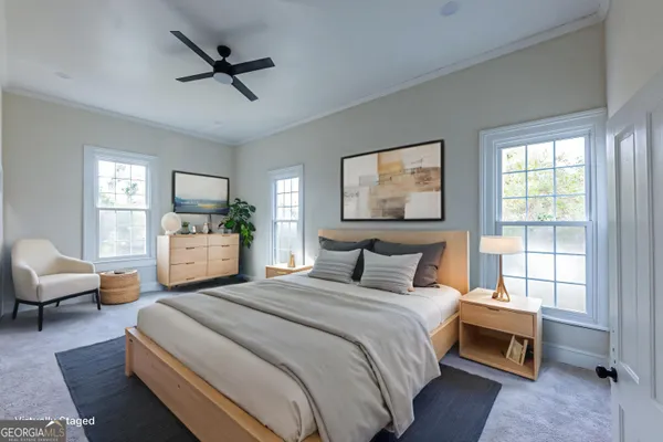 a bedroom with a bed couch and window