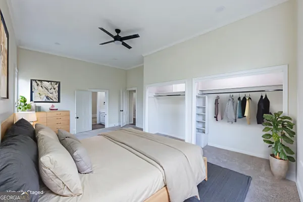 a bedroom with a balcony a bed and a potted plant