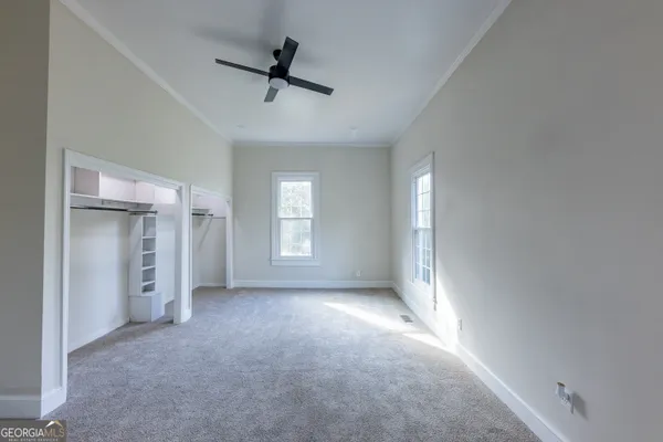 a view of a livingroom with a ceiling fan and window