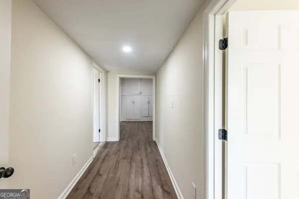a view of a hallway with wooden floor