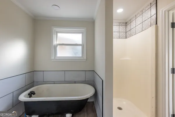a bathroom with a bathtub and shower