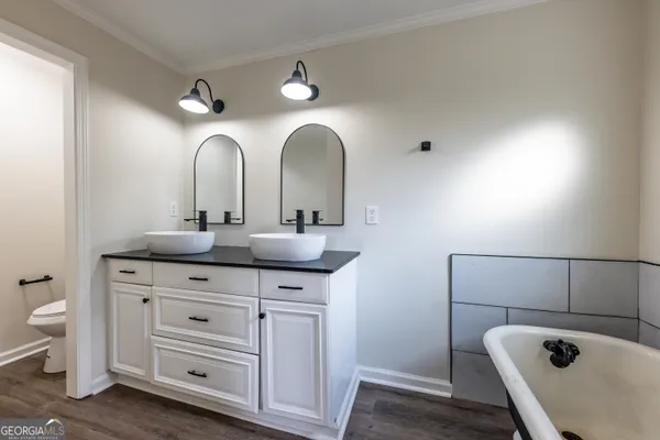 a bathroom with a double vanity sink and a toilet