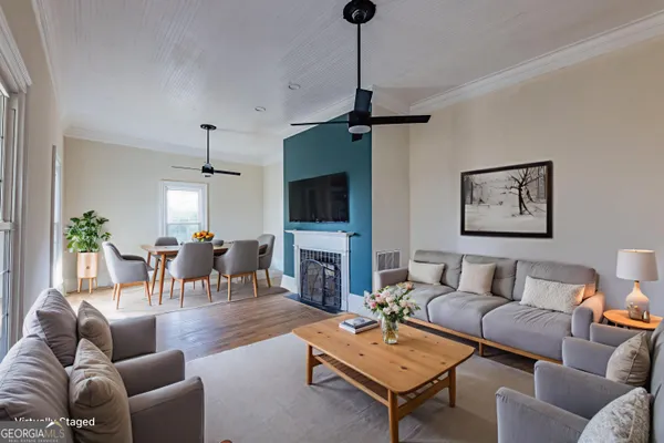 a living room with furniture a fireplace and a flat screen tv