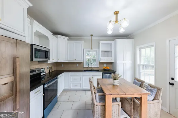 a kitchen with a sink a stove and cabinets