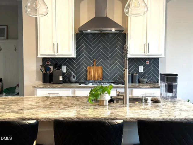 a kitchen with sink and chairs