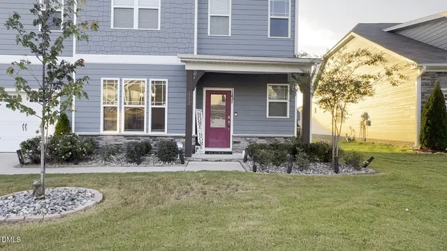 a living room with furniture a dining table and a window